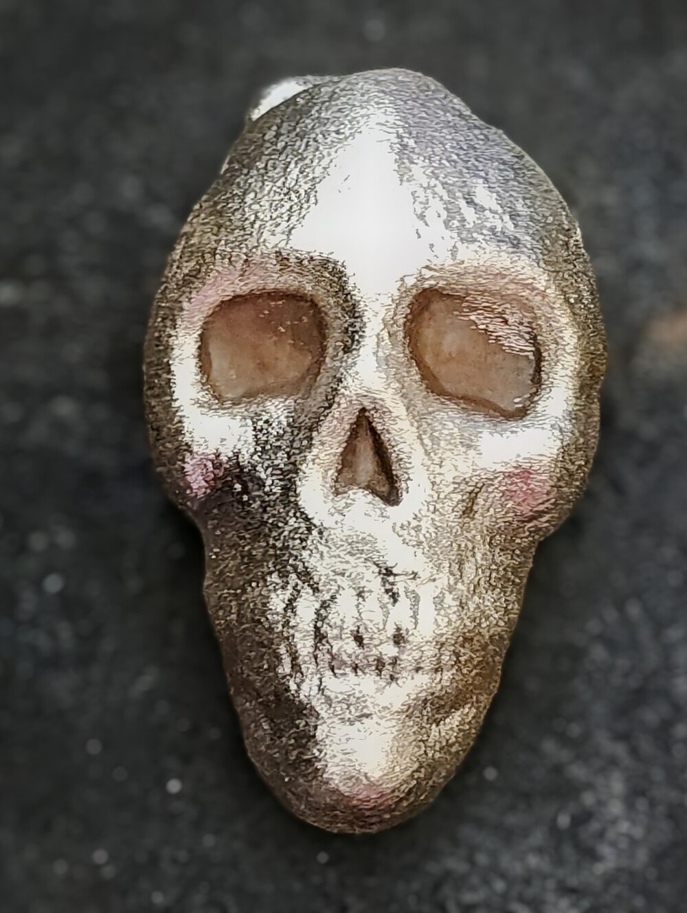 Small batch hand-poured silver skull with a raw gothic relic aesthetic.